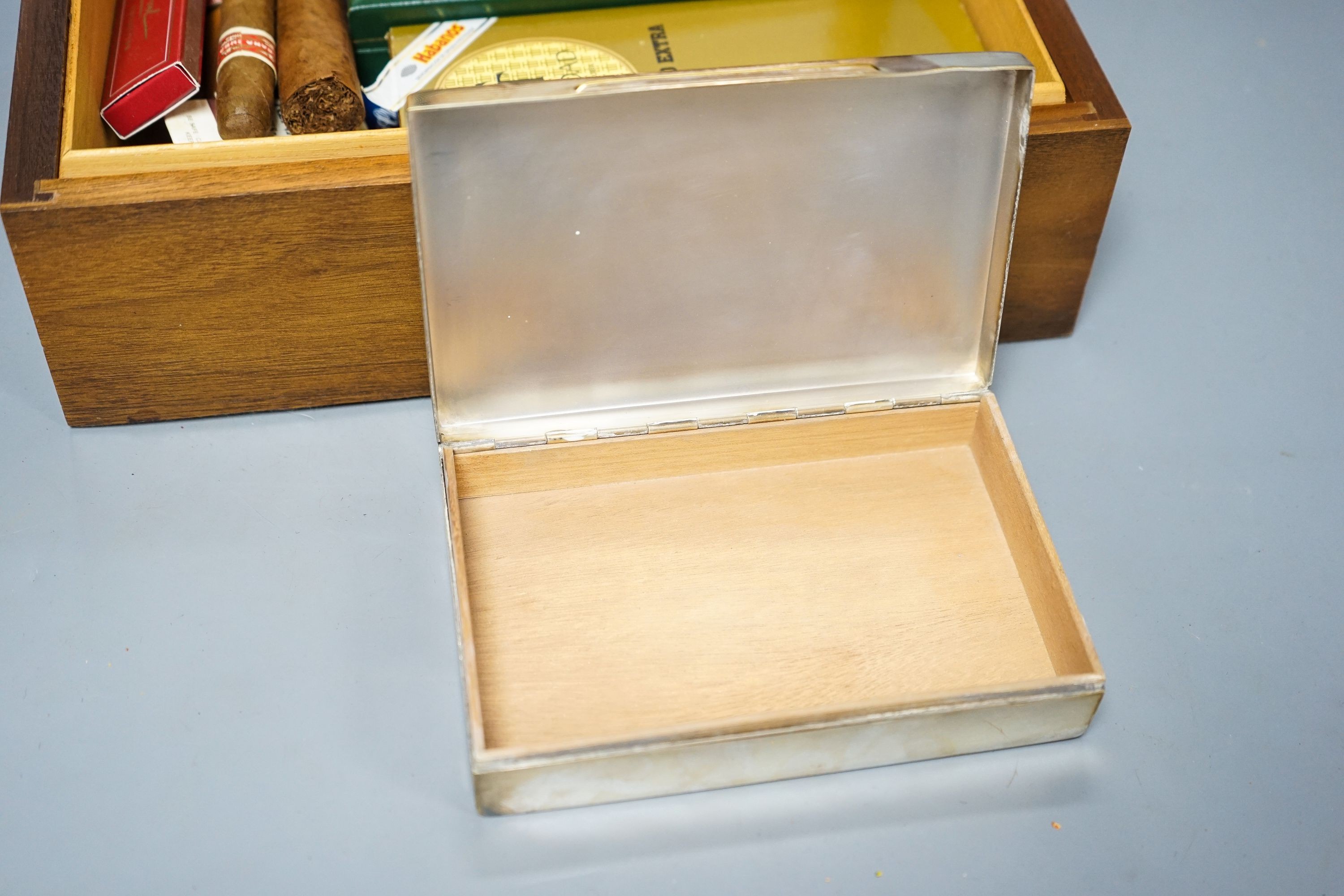 A cased Davidoff cigar cutter, walnut humidor, plated cigarette box, various cigars etc.
